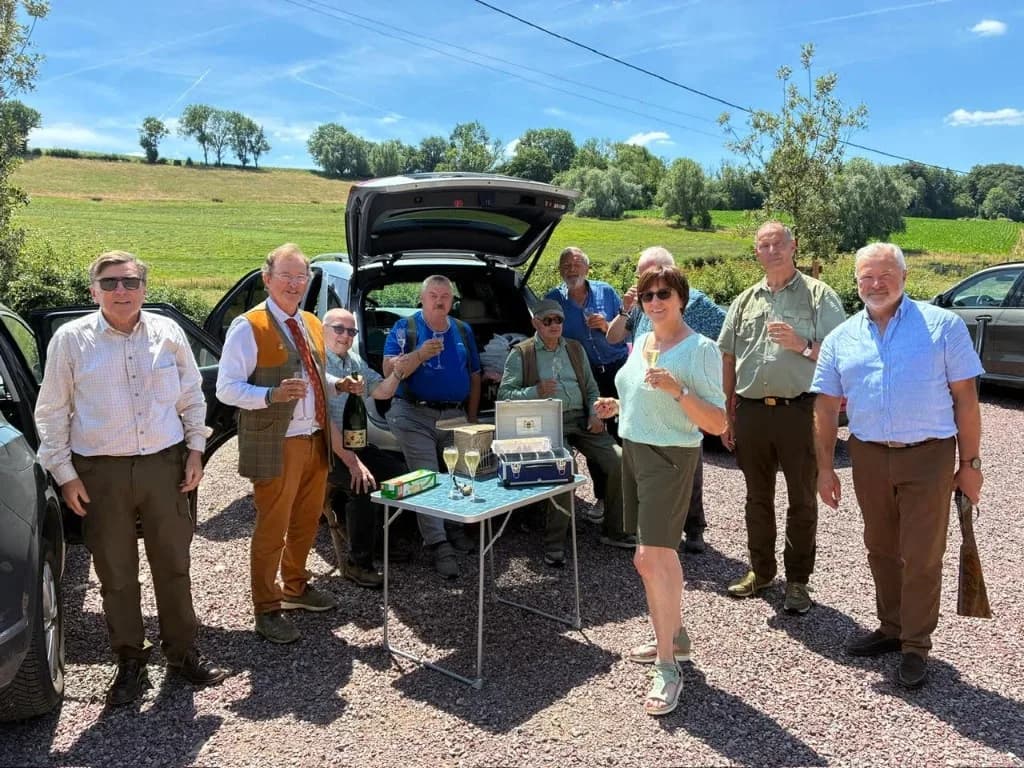 Groupe d'amis trinquant au champagne après une matinée de battue simulée au Domaine de La Planquette